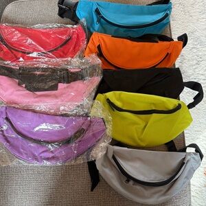 8 New or like new fanny packs in multiple colors